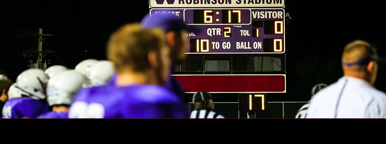 A high school football score board with Zenith Crest Trust Bank logo.